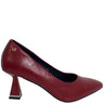 A single red leather pump with a pointed toe and a distinctive geometric block heel, shown from a side profile on a white background.