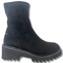 Black boot with a thick sole on a white background