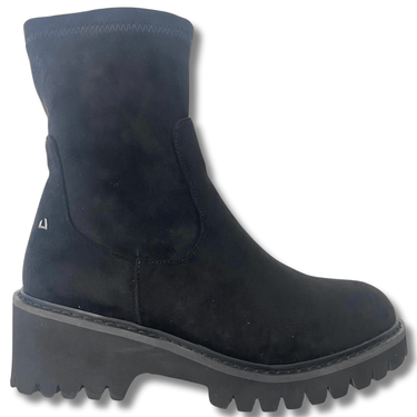Black boot with a thick sole on a white background