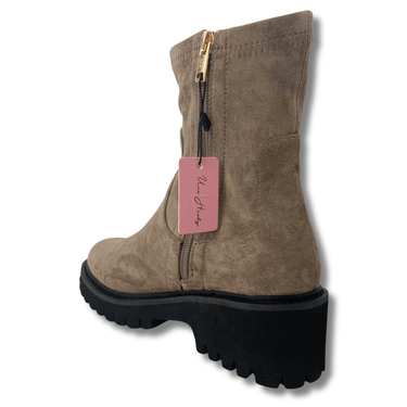 Brown suede boot with a pink tag on a white background