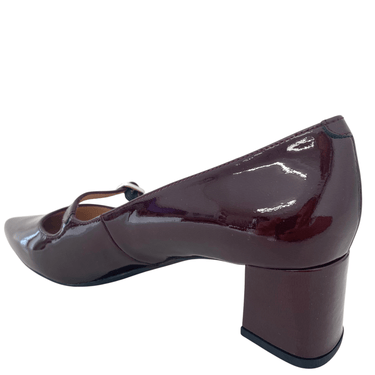 Patent leather high heel shoe on a white background