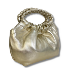 Gold metallic handbag with braided handle on a white background