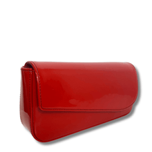 Red patent leather clutch bag on a white background