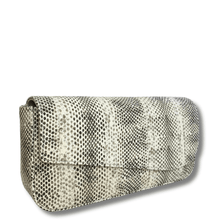 Snake skin patterned clutch bag on a white background