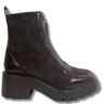 A dark brown ankle boot with a mix of suede and patent leather panels, featuring a chunky platform sole and a side zipper, shown against a plain white background.