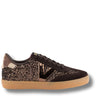 A low-top sneaker featuring dark brown suede and glittery metallic bronze panels, black laces, and a light tan gum sole, shown against a plain white background.