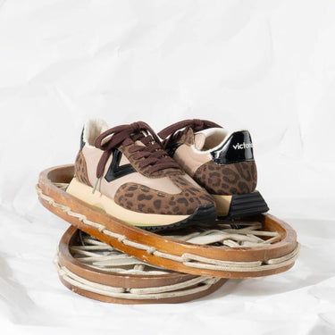 Pair of leopard print sneakers on a white background