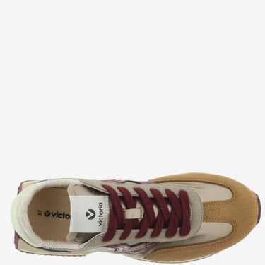 Tan and white sneaker with maroon laces on a white background