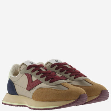 Pair of brown and red sneakers on a white background