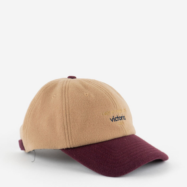 Beige and maroon cap with text on a white background