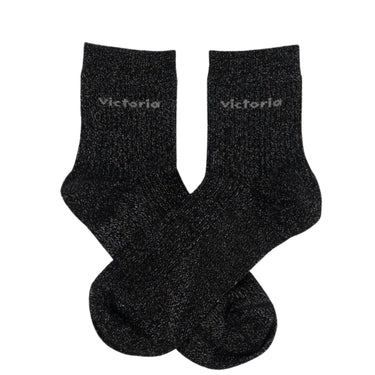 Pair of black socks with 'Victoria' branding on a white background