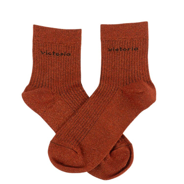 Pair of brown socks with 'Victoria' branding on a white background