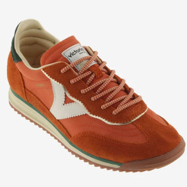 Orange sneaker with white logo on a white background