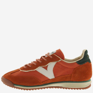 Orange sneaker with a white 'V' logo on a white background