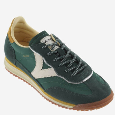 Green sneaker with white accents on a white background