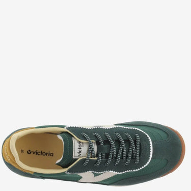 Green sneaker with white accents on a white background