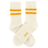 Pair of cream socks with orange stripes on a white background