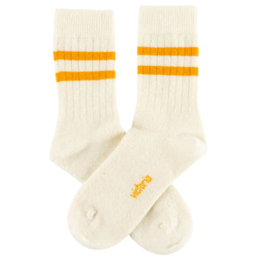 Pair of cream socks with orange stripes on a white background