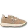 A beige suede sneaker with a metallic silver chevron logo on the side, beige laces, and a thick cream-colored midsole, shown against a plain white background.