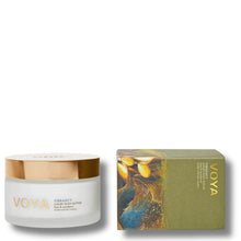 VOYA Body Butter in a frosted glass jar with a metallic gold lid, shown next to its olive green and gold illustrated packaging box on a white background.