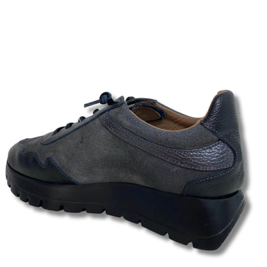 Blue sneaker with a thick sole on a white background