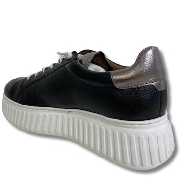 Black sneaker with white sole on a white background