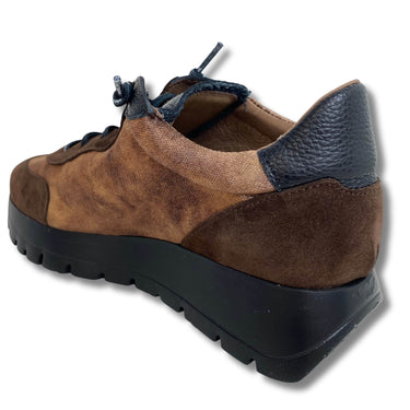 Brown suede shoe with black sole on a white background