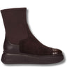 A dark brown ankle boot with a textured leather side panel, suede-like upper, elastic side gore, and a chunky ribbed sole, shown against a plain white background.