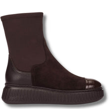 A dark brown ankle boot with a textured leather side panel, suede-like upper, elastic side gore, and a chunky ribbed sole, shown against a plain white background.