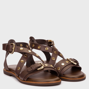 Pair of brown sandals with gold buckles and studs on a white background