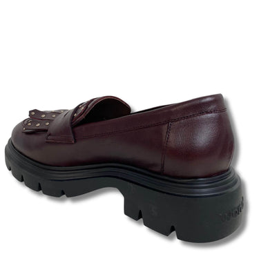 Brown leather loafer with thick black sole on a white background