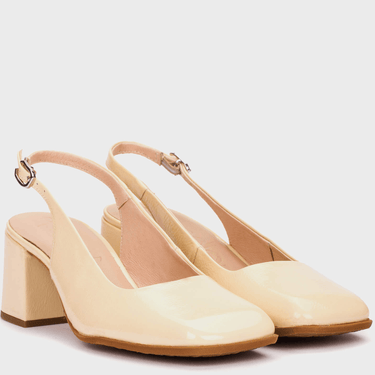 Pair of beige high-heeled shoes on a light background