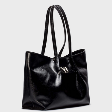 Black leather tote bag with a visible brand logo on a light gray background