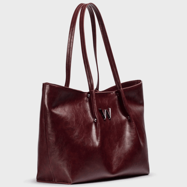 wine toned leather tote bag with a visible brand logo on a light gray background