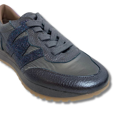 Gray sneaker with blue glittery accents on a white background
