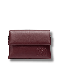 wine toned leather clutch bag with 'wonders' branding on a white background