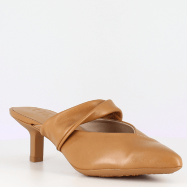 Tan leather mule shoe on a white background