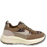 A low-top sneaker in shades of brown, beige, and gray, featuring a leopard print pattern on the toe and side panels, a chunky textured off-white sole, and gray laces.