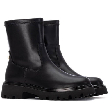 Pair of black leather boots on a white background