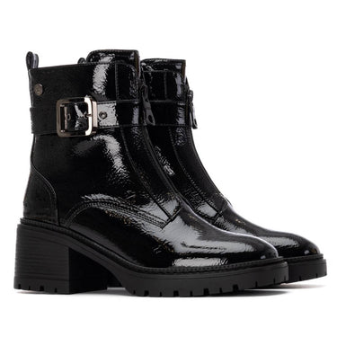 Black patent leather boots with buckles on a white background