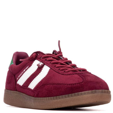 Maroon sneaker with white stripes on a white background