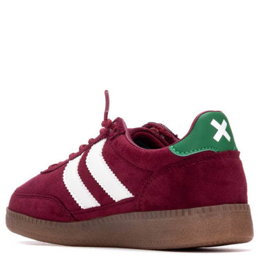 Maroon sneaker with white stripes and green accents on a white background