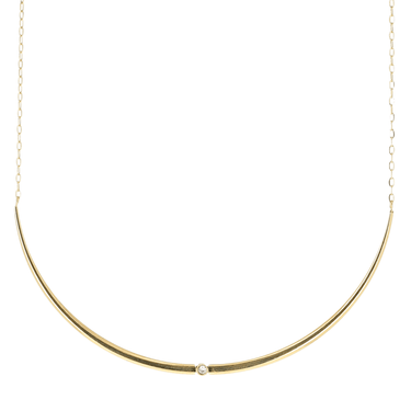 Gold necklace with a small pearl on a white background