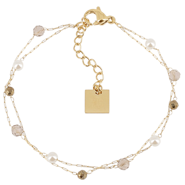 Gold bracelet with beads and a square charm on a white background