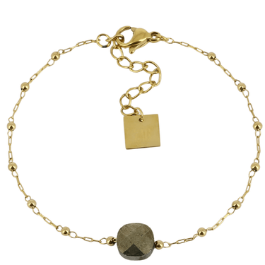 Gold bracelet with a central stone on a white background