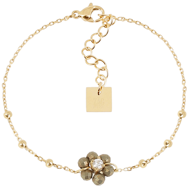 Gold bracelet with a floral charm and square tag on a white background