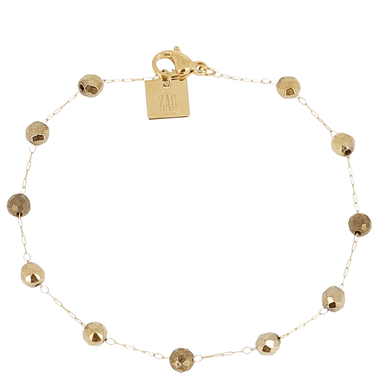 Gold bracelet with beaded design on a white background