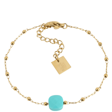 Gold bracelet with a turquoise bead on a white background